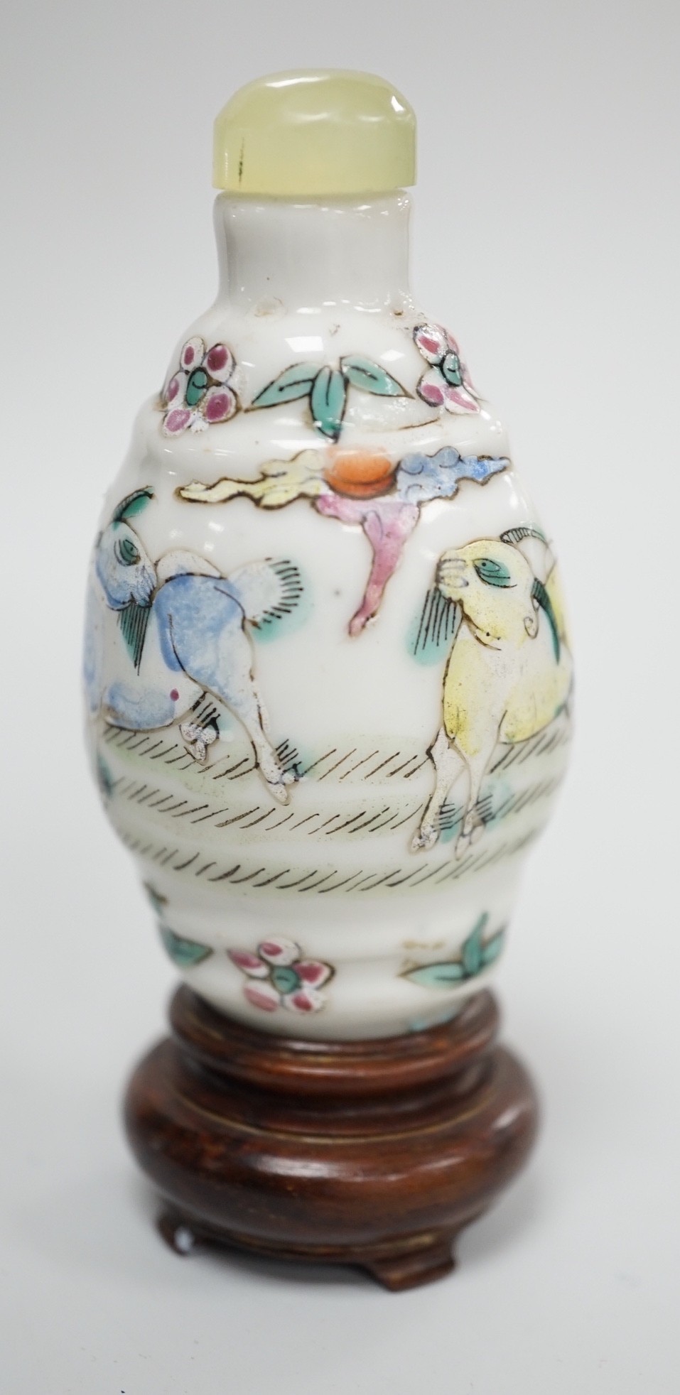 A Chinese famille rose snuff bottle, decorated with rams, Qianlong mark, 1850-1900, 6.7 cm high